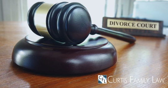 gavel on table with sign that says divorce court in the background